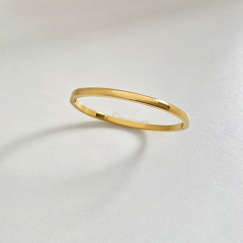 The Slim Gold Buckle Bangle, 4 mm gold, included in The Heirloom Stack