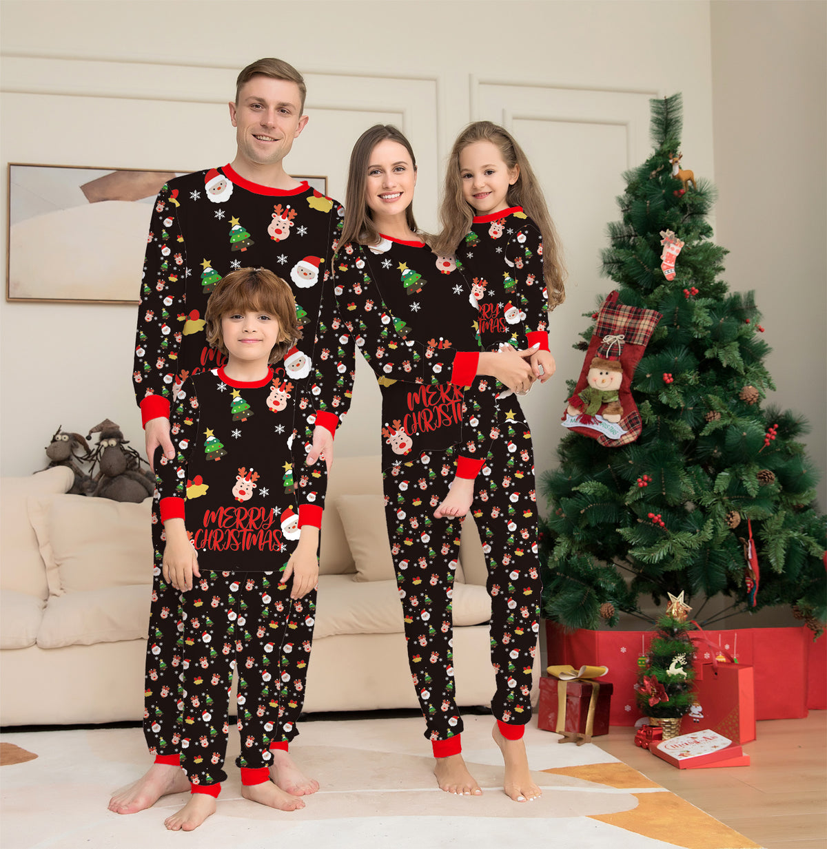 Family in matching Christmas Night pajamas by the tree